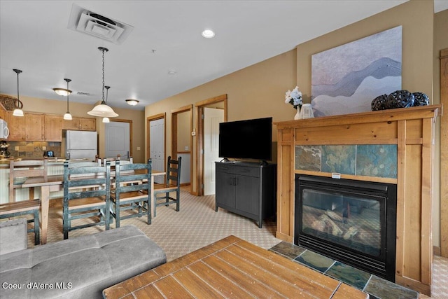 carpeted living room featuring a fireplace