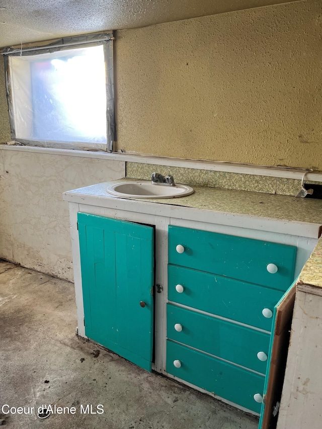 bathroom with sink and concrete floors