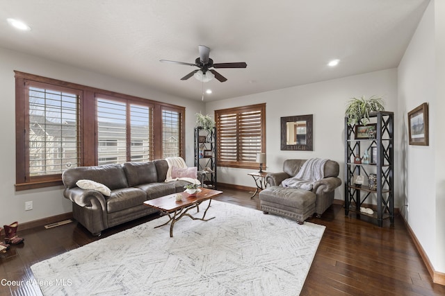 living room with ceiling fan and dark hardwood / wood-style flooring