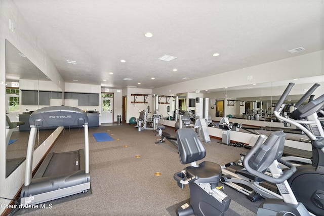 gym featuring a textured ceiling