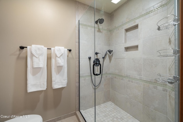 bathroom featuring an enclosed shower and toilet