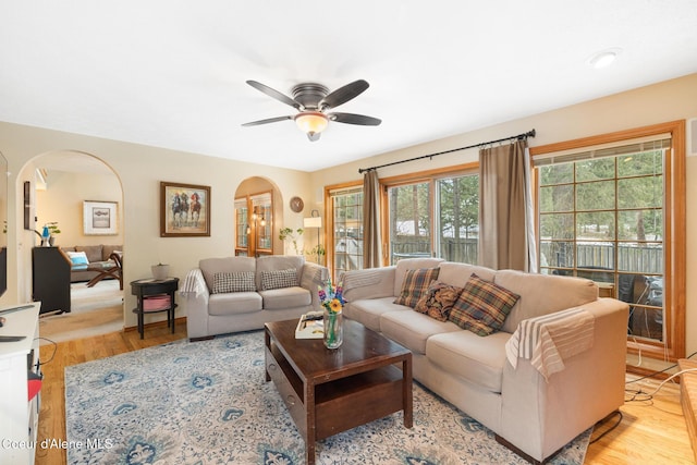 living room with light hardwood / wood-style floors and ceiling fan