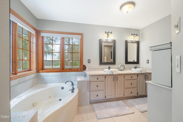 bathroom with vanity, tile patterned flooring, and a tub