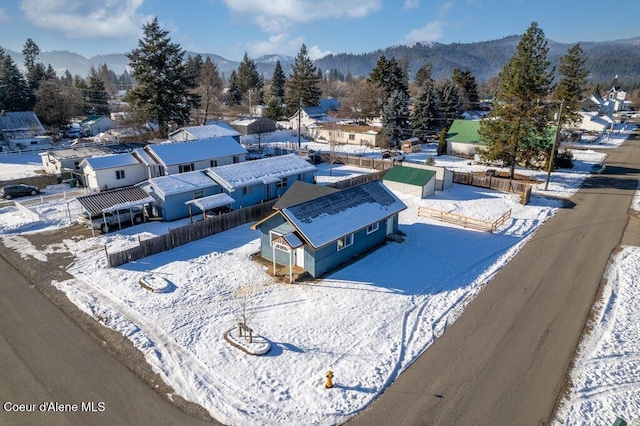 snowy aerial view featuring a mountain view