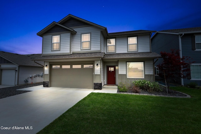 view of front of home with a garage and a yard