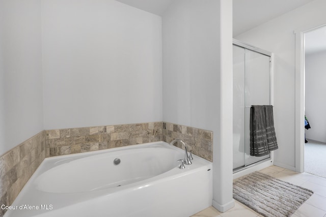 bathroom with tile patterned floors and shower with separate bathtub