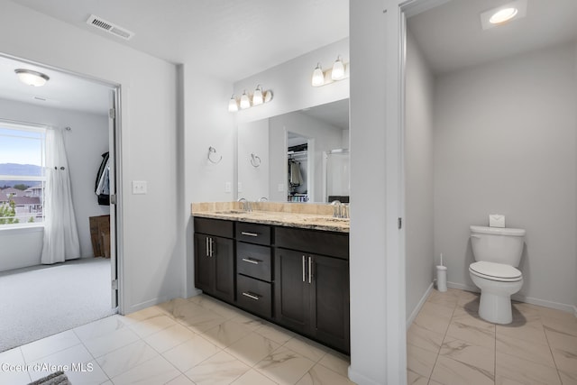 bathroom featuring vanity and toilet