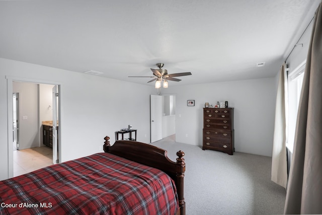 carpeted bedroom with connected bathroom and ceiling fan