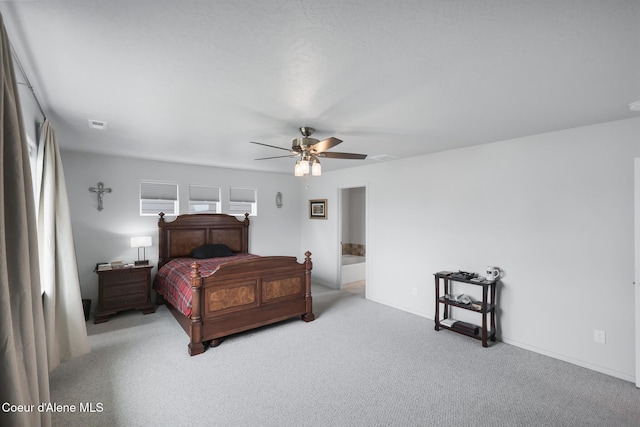 bedroom featuring light carpet, connected bathroom, and ceiling fan