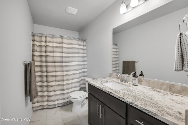 bathroom featuring vanity, toilet, and a textured ceiling