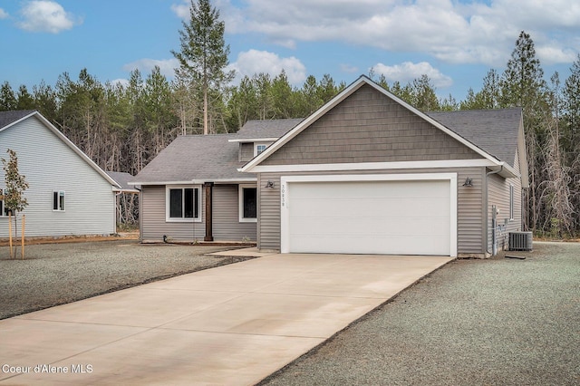 211 Rain Dr, Athol, ID 83801 - view of front of property featuring an attached garage, roof with shingles, central AC, and concrete driveway