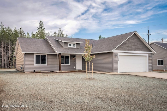 211 Rain Dr, Athol, ID 83801 - view of front of property featuring concrete driveway, roof with shingles, and a garage