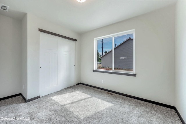 211 Rain Dr, Athol, ID 83801 - unfurnished bedroom featuring visible vents, carpet, baseboards, and a closet