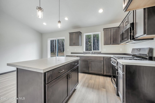 211 Rain Dr, Athol, ID 83801 - kitchen with light wood-type flooring, light countertops, a sink, appliances with stainless steel finishes, and decorative light fixtures