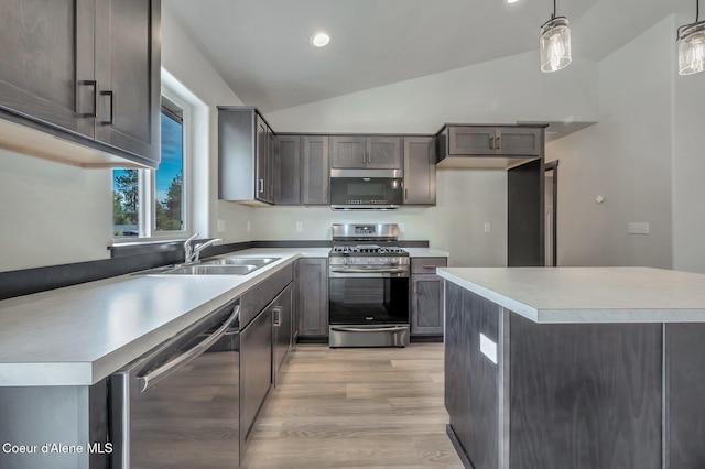 211 Rain Dr, Athol, ID 83801 - kitchen featuring a sink, light countertops, lofted ceiling, stainless steel appliances, and light wood-style flooring