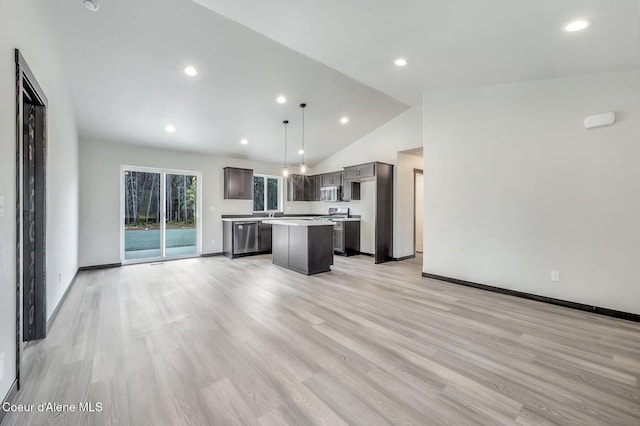 211 Rain Dr, Athol, ID 83801 - kitchen with lofted ceiling, a kitchen island, light countertops, light wood-style flooring, and stainless steel appliances