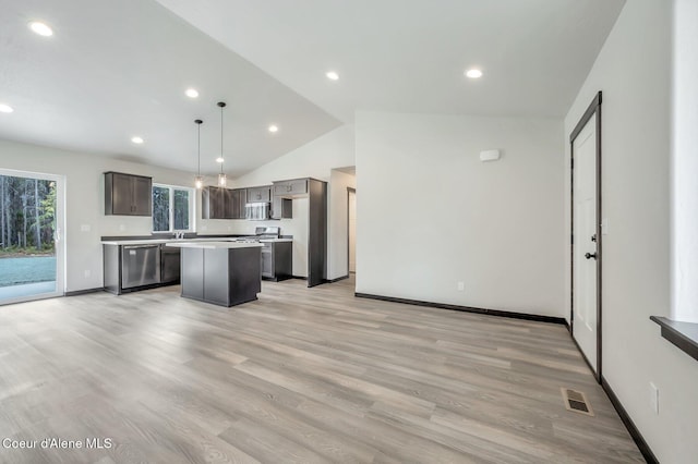 211 Rain Dr, Athol, ID 83801 - kitchen with visible vents, a center island, light countertops, lofted ceiling, and stainless steel appliances