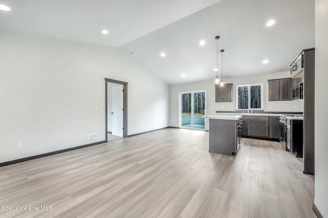 211 Rain Dr, Athol, ID 83801 - kitchen featuring light countertops, appliances with stainless steel finishes, light wood finished floors, and a center island