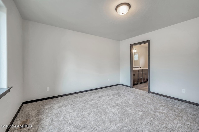 211 Rain Dr, Athol, ID 83801 - empty room featuring carpet floors, baseboards, and a sink