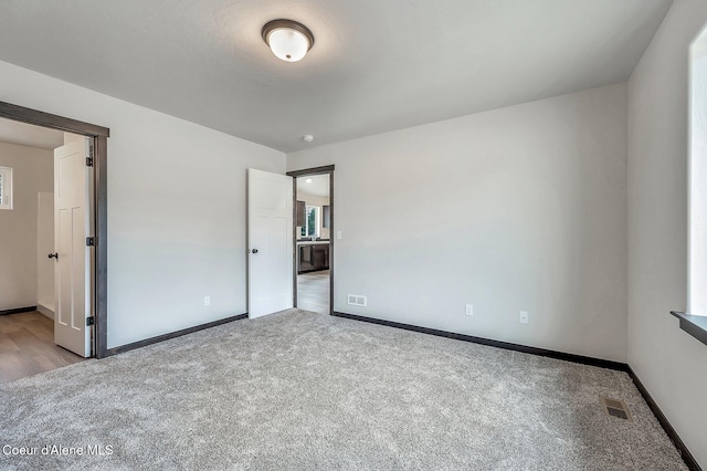 211 Rain Dr, Athol, ID 83801 - unfurnished bedroom featuring baseboards, carpet flooring, and visible vents