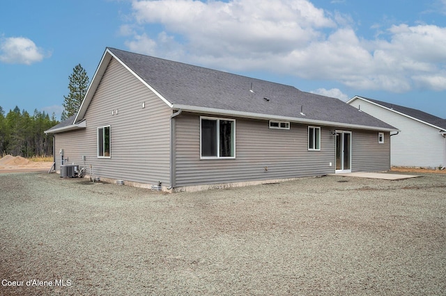 211 Rain Dr, Athol, ID 83801 - rear view of house featuring a shingled roof, cooling unit, and a patio area