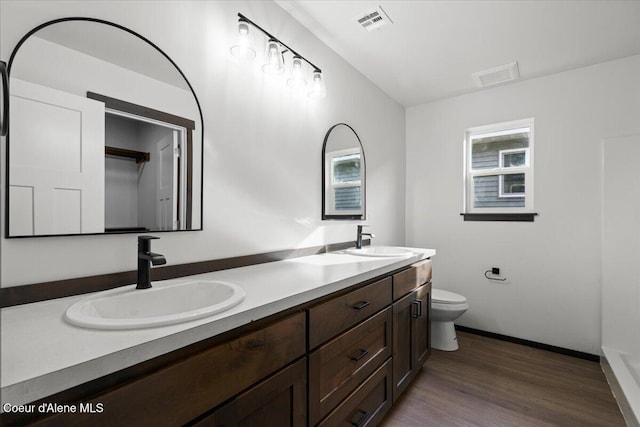 bathroom featuring vanity, hardwood / wood-style floors, and toilet