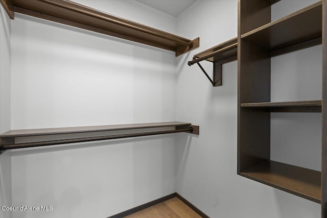 spacious closet featuring hardwood / wood-style flooring