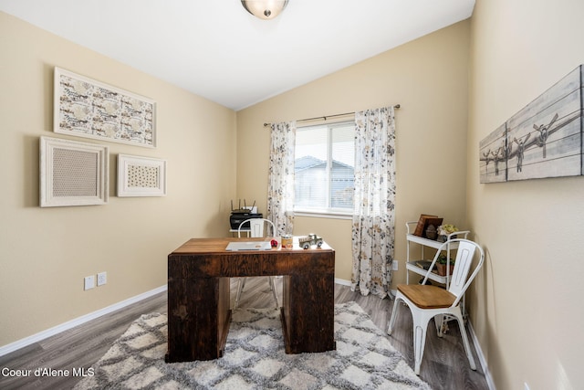 office featuring lofted ceiling and hardwood / wood-style floors