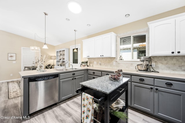 kitchen with sink, gray cabinets, dishwasher, white cabinetry, and hanging light fixtures