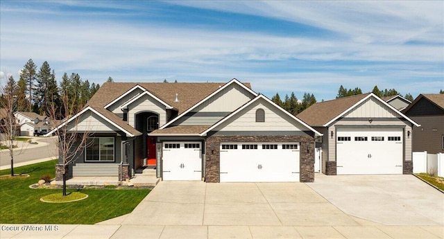 craftsman-style home with a garage and a front yard