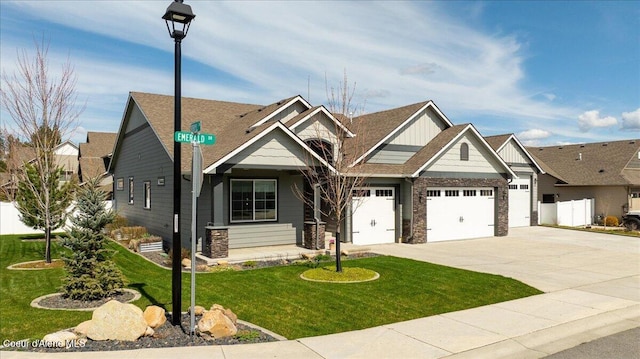 craftsman-style house with a garage and a front lawn