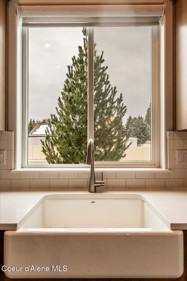 details featuring tasteful backsplash and sink