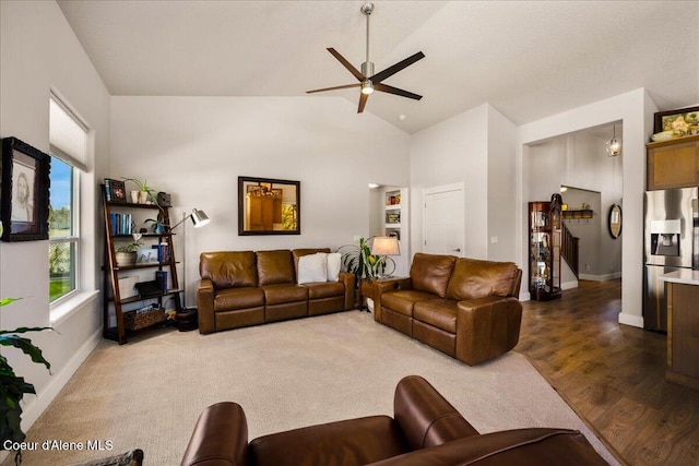 living room featuring lofted ceiling, wood-type flooring, and ceiling fan