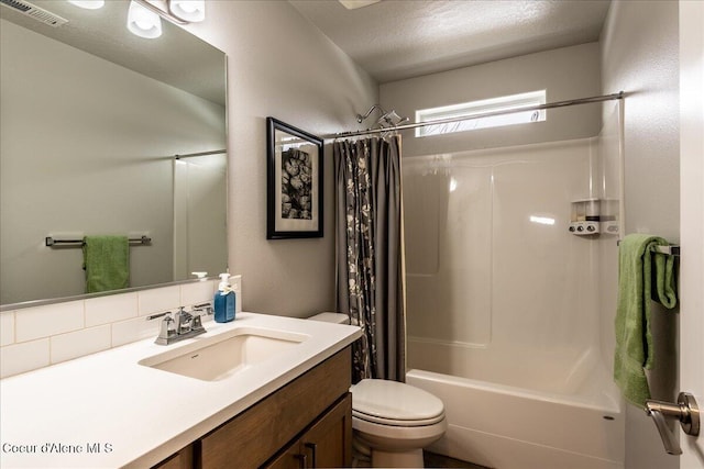 full bathroom featuring vanity, shower / bath combination with curtain, a textured ceiling, decorative backsplash, and toilet