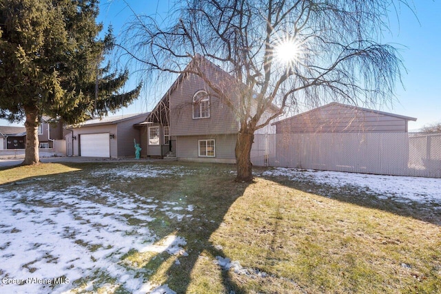 view of front of house featuring a garage and a lawn