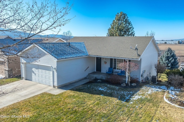 ranch-style home featuring a garage, a front yard, and central air condition unit