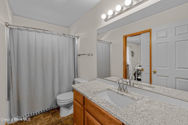 bathroom with vanity, curtained shower, and toilet