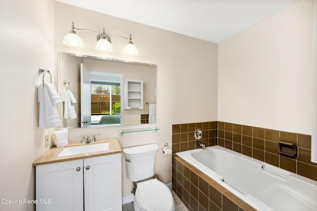 bathroom with tiled tub, vanity, and toilet