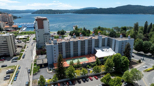 birds eye view of property with a water and mountain view