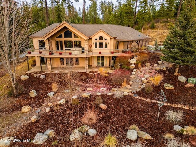 rear view of property featuring a wooden deck