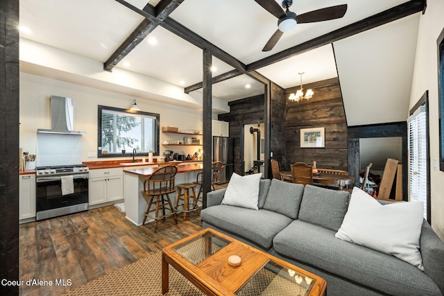 living room featuring dark wood-type flooring, coffered ceiling, sink, wooden walls, and beam ceiling