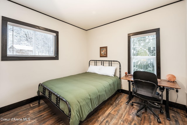 bedroom with dark hardwood / wood-style flooring