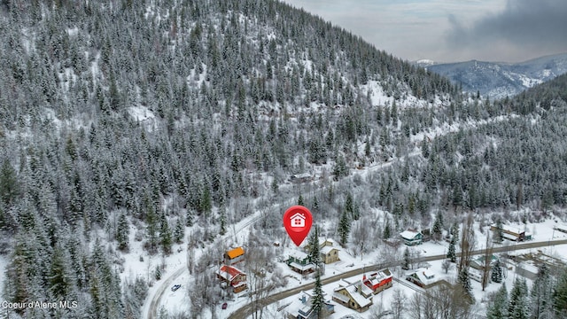 snowy aerial view with a mountain view