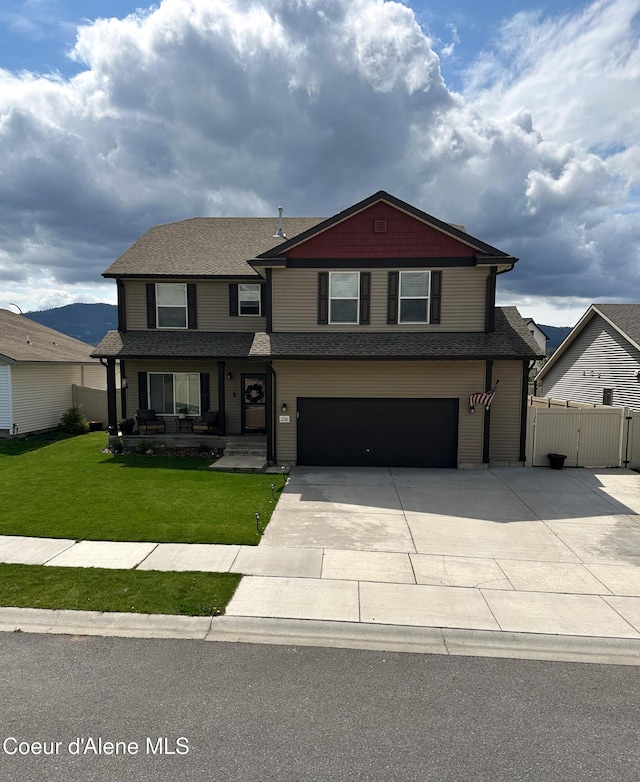 2126 Lapwai Ave, Post Falls, ID 83854 - view of front of home featuring concrete driveway, a garage, a gate, a porch, and roof with shingles
