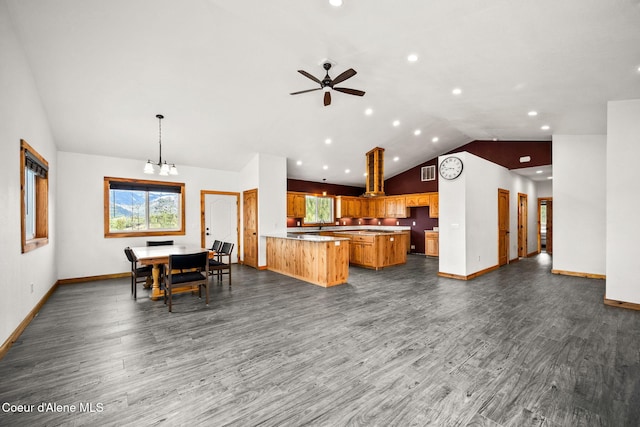 kitchen featuring visible vents, dark wood-type flooring, open floor plan, baseboards, and lofted ceiling