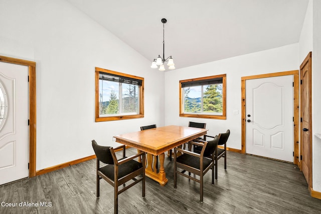 dining room featuring an inviting chandelier, baseboards, lofted ceiling, and wood finished floors