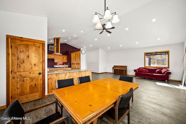 dining room with lofted ceiling, recessed lighting, wood finished floors, and baseboards