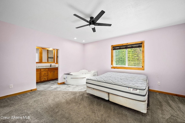 bedroom with light carpet, baseboards, and a sink