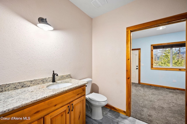 bathroom with visible vents, baseboards, toilet, and vanity