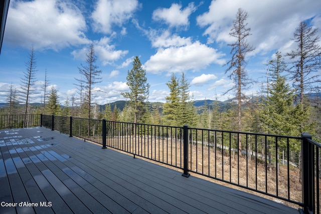 wooden deck with a wooded view